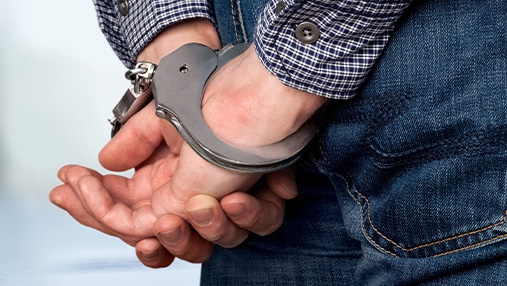 persons hands in handcuffs