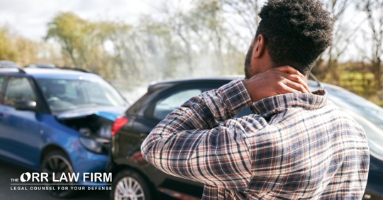 man looking at a car accident