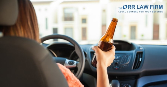 driver holding a beer bottle